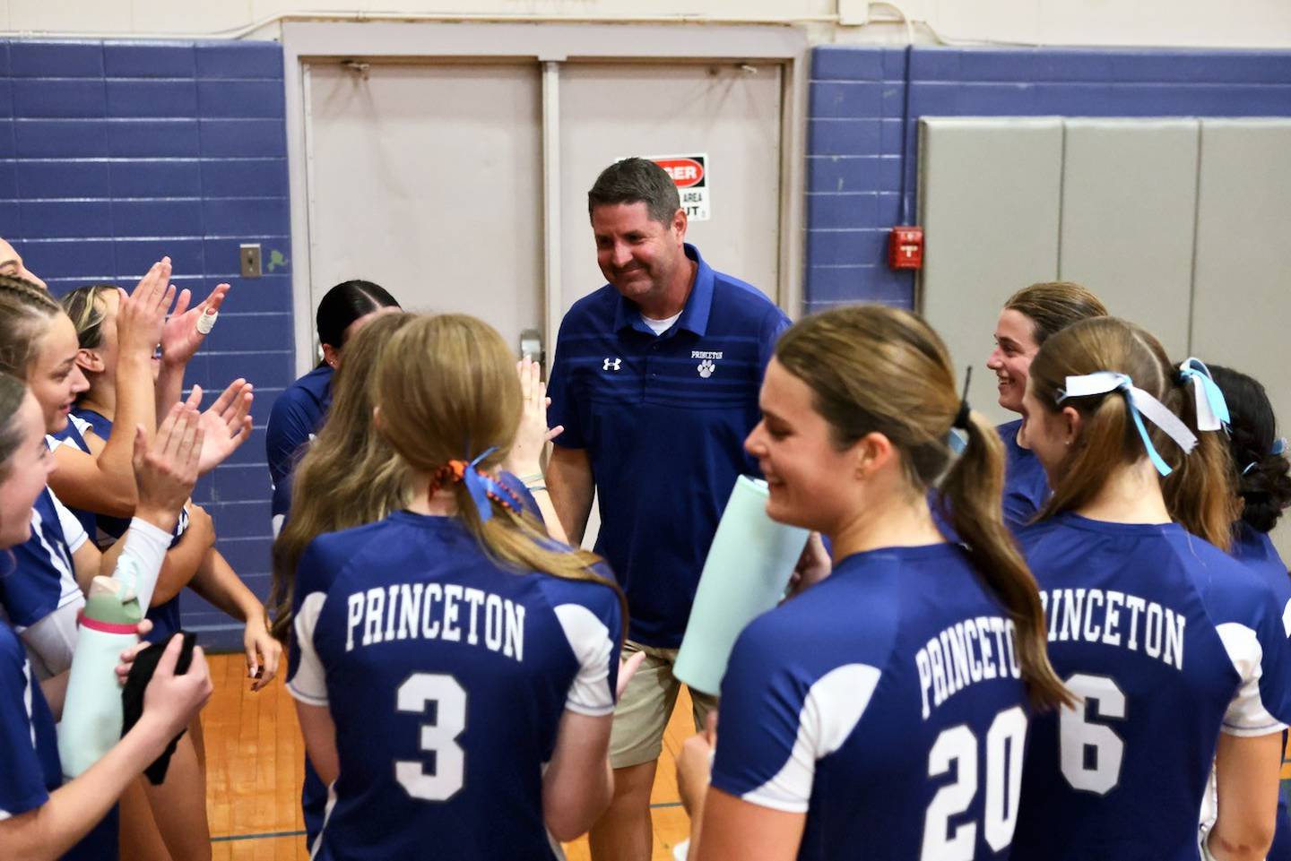 Princeton coach Andy Puck celebrates the moment of his 500th career victory with his team after the Tigresses defeated Mendota 25-23, 25-19 Tuesday night at Prouty Gym.