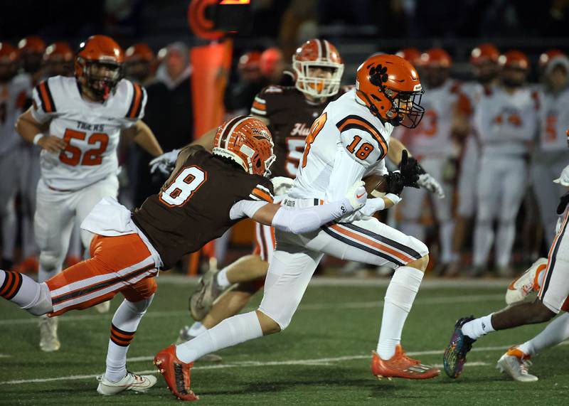 Hersey's Carson Grove (8) tries to pull down Wheaton Warrenville South's Joe Preede (18) during the IHSA Class 7A playoffs Saturday October 28, 2023 in Arlington Heights.