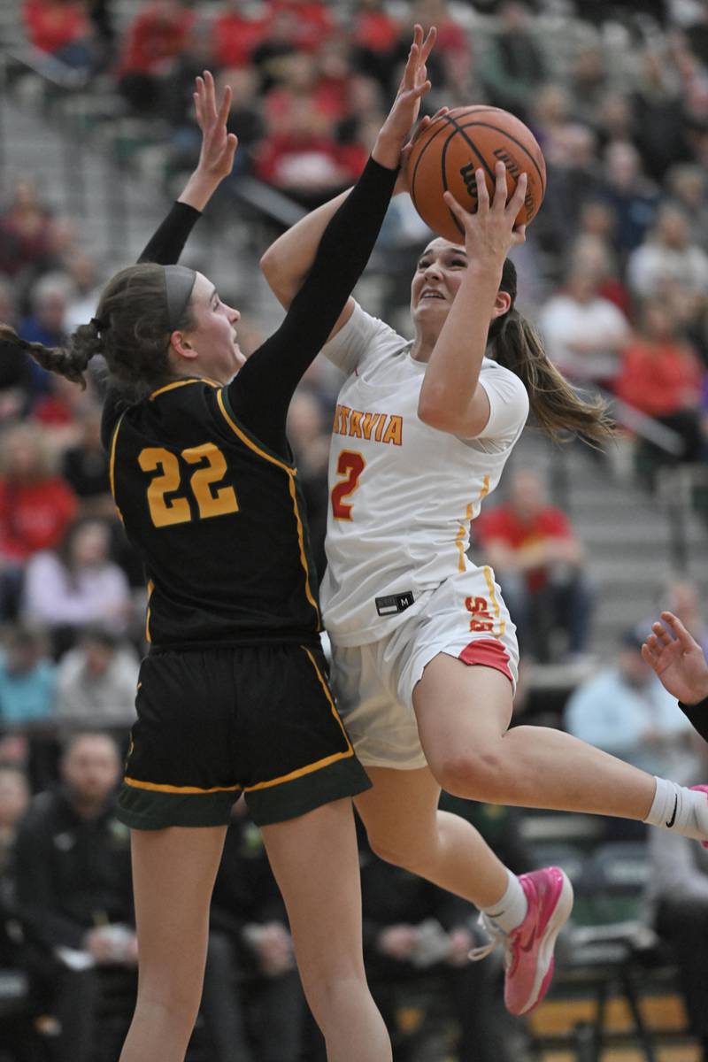 Batavia’s Brooke Carlson shoots around Fremd’s Ella Todd in the Bartlett supersectional game on Monday, Feb. 26, 2024.