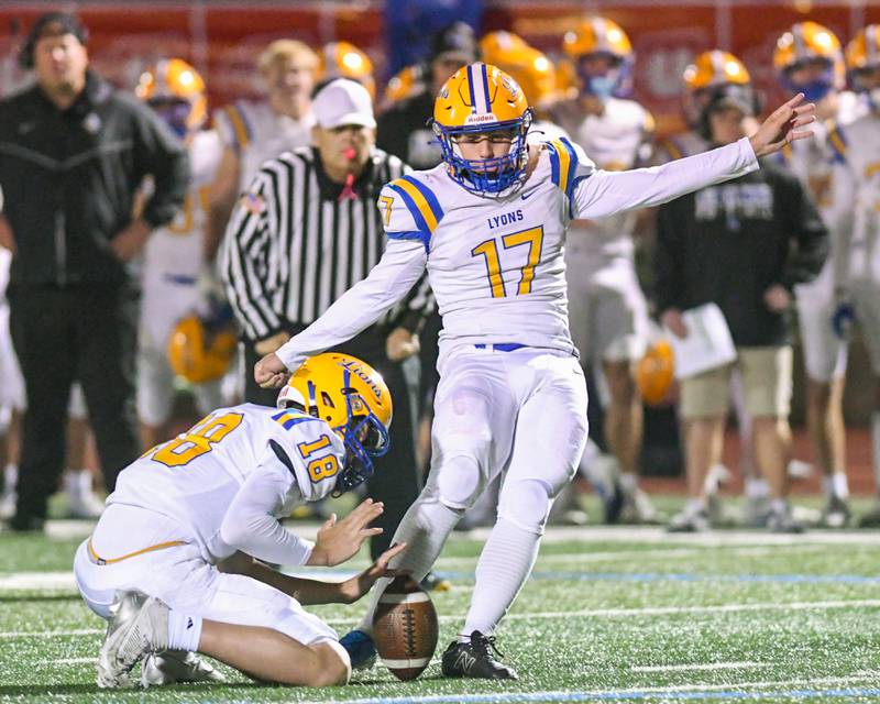 Lyons Township's AJ Vavrik (17) makes a field goal as teammate Lyons Township's Jack Slightom (18) holds the ball during the game on Friday Oct. 18, 2024, as they traveled to York High School in Elmhurst.