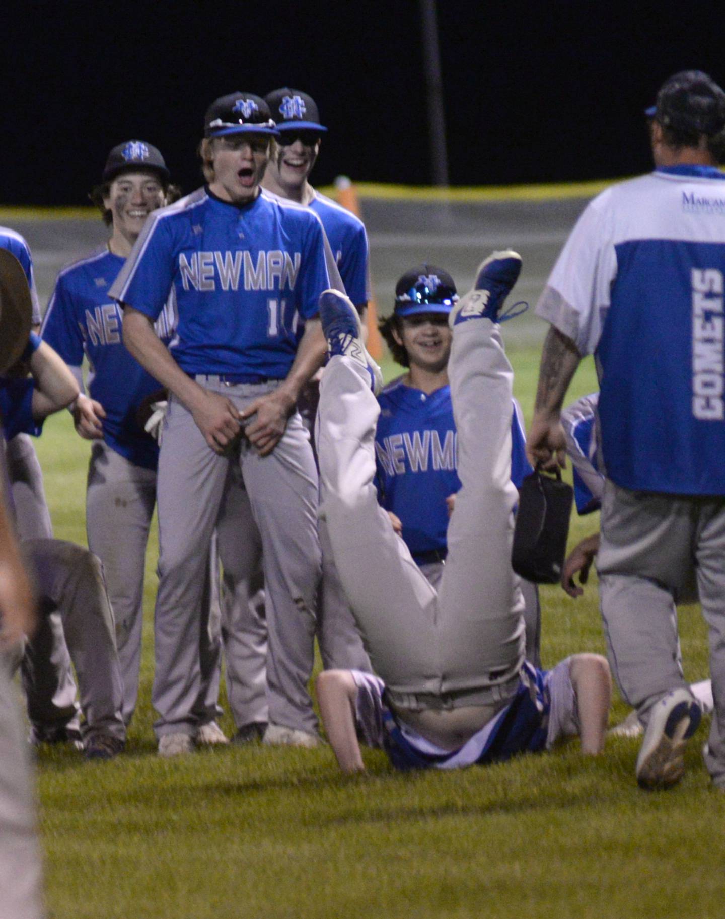 Newman players have some fun watching one of their teammates do a belly flop after beating Pearl City at the 1A Pearl City Sectional on Wednesday, May 24.