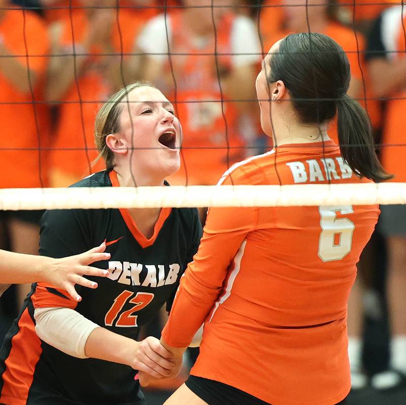 DeKalb's Molly Fell (left) celebrates a point with Adisyn Galijatovic during their match against Sycamore Wednesday, Aug. 28, 2024, at DeKalb High School.