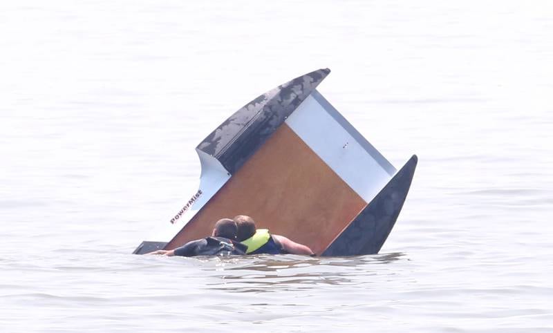 Safety crews help flip Nick Hooten's boat around after it capsized during the US Title Series Pro National Championship Boat Races on Friday, July 26, 2024 at Lake DePue.