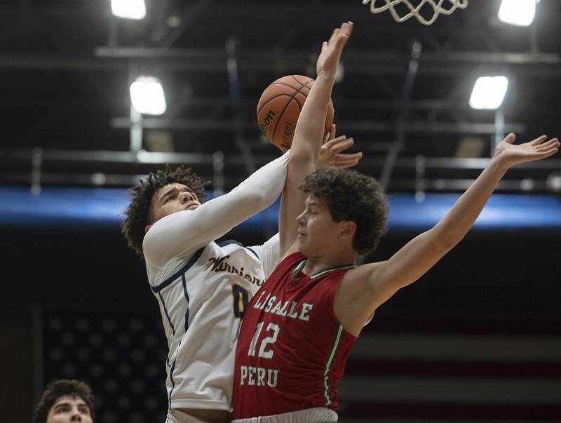 Sterling’s Andre Klaver goes to the hoop against LaSalle-Peru’s Michael Hartman Friday, Feb. 23, 2024 during a class 3A regional final at Sterling High School.