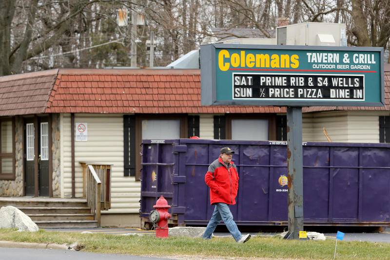 A pedestrian walks past the former Colemans Tavern & Grill building on Monday, Nov. 30, 2020, in Woodstock.