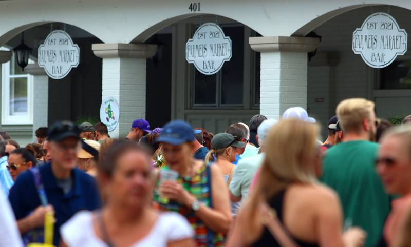 Visitors enjoy The Dole Farmers Market in Crystal Lake Sunday.