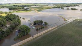 Rail bridge collapses during Midwest flooding as a heat wave persists across much of the US