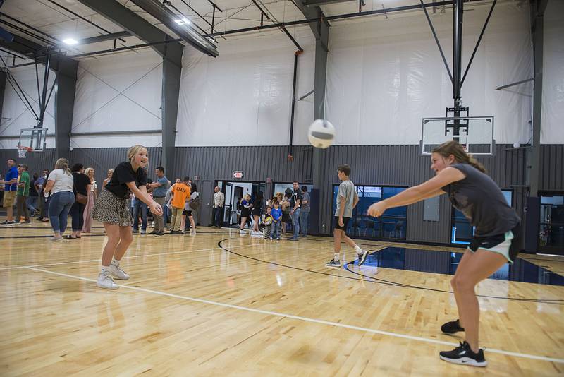 Emma Nicklaus (left), 11 and Brooklyn Tegeler, 11, pass the volleyball back and forth during the opening ceremonies of Dixon Park District's Facility Friday, August 19, 2022. The indoor facility accommodates volleyball and basketball courts, batting cages and other large scale gatherings.