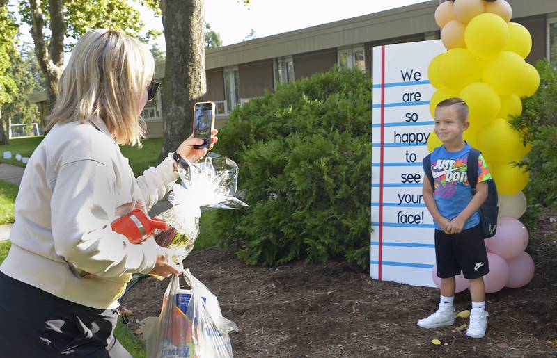 Kayla Allegretto takes a photo Wednesday, Aug. 21, 2024, of her son Luca outside of McKinley School in Ottawa on the first day of school.