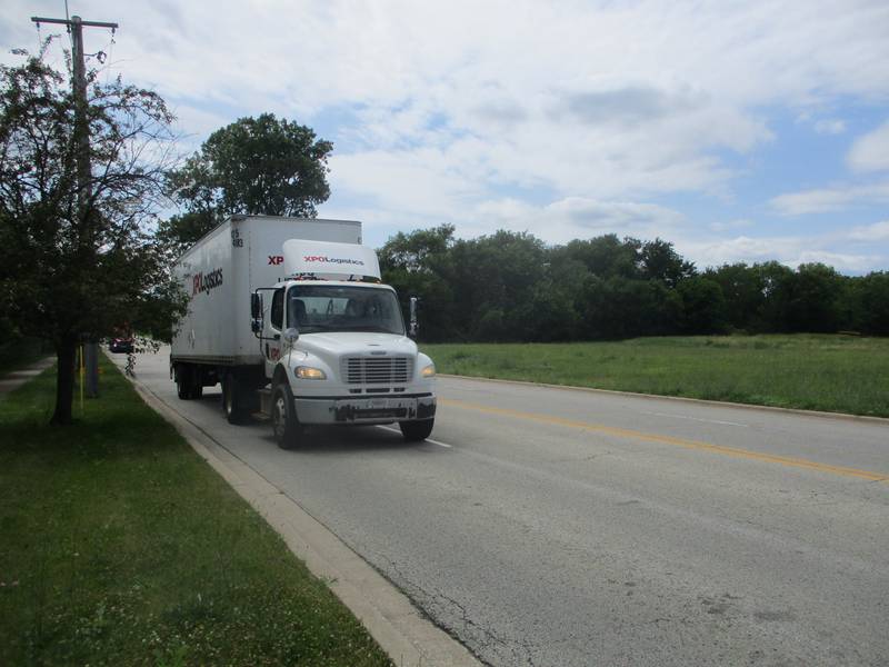 A semitrailer drives past the 31-acre site at 3801 Division St. where MWI Property Group wants to build a warehouse and possible assembly plant. June 24, 2024