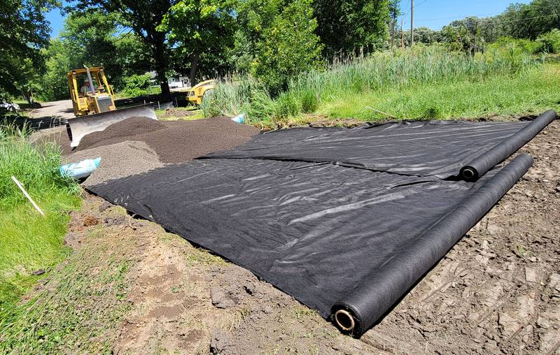 Rick Stott of Stott Contracting in Morris uses a plow to level off the fill around a culvert, part of the Green Street Elevation Project now underway on the east side of Ottawa.