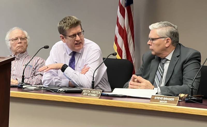 Second Ward Alderman, Chuck Stowe (left) and city attorney Keith Foster (right) listen as Sycamore City Manager Michael Hall (center) talks during the March 20, 2023 Sycamore City Council meeting.