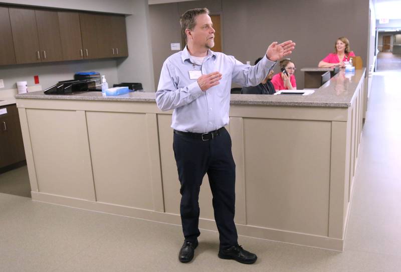 Bart Becker, administrator of the DeKalb County Rehabilitation and Nursing Center, talks Wednesday, July 10, 2024, about the nurses station, spacious rooms and hallways in the center’s new transitional care wing. The new addition recently opened and residents have begun moving in.