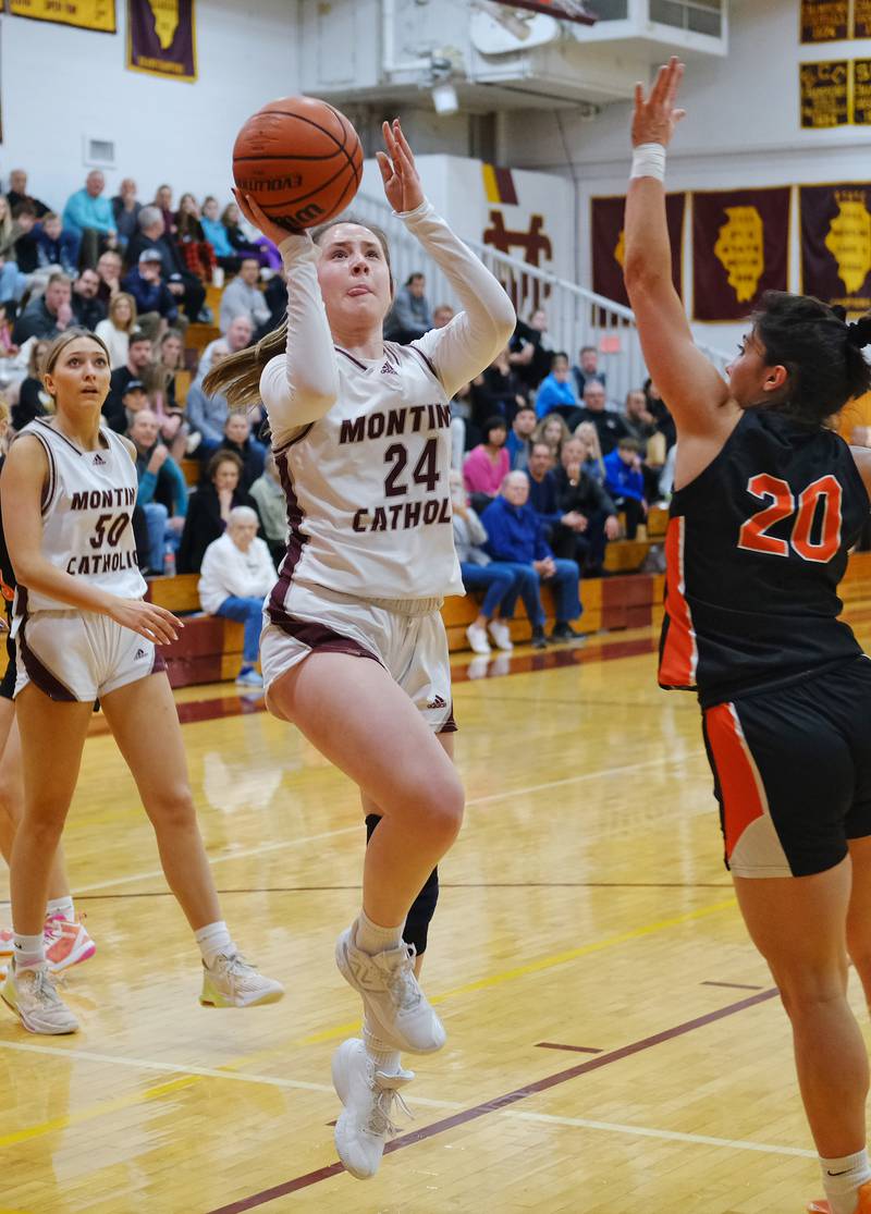 Montini's Peyton Farrell (24) shoots as St. Charles East's Alexis Maridis (20) defends during the Montini Christmas Tournament championship game on Dec. 29, 2023 at Montini Catholic High School in Lombard.