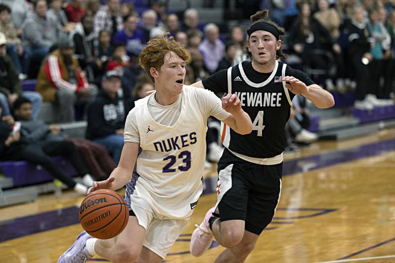 Dixon’s Austin Hicks drives past Kewanee’s Blaise Lewis Tuesday, Nov. 28, 2023 in Dixon.