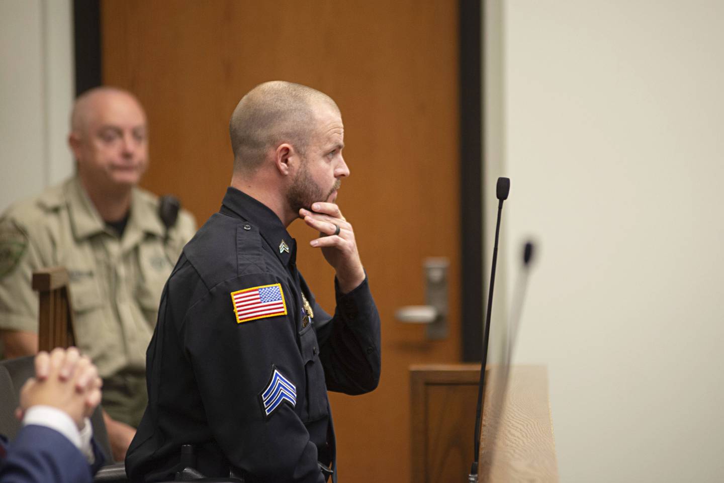Dixon police officer Ryan Bivins watches surveillance video of the May 2018 shooting at Dixon High School by Matthew Milby. Bivins was a prosecution witness in the case.