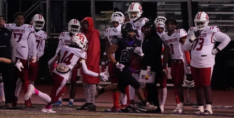 Downers Grove North's Noah Battle (20) runs after the catch for a touchdown against Kenwood during a class 7A playoff football game at Downers Grove North on Friday, Oct. 27, 2023.