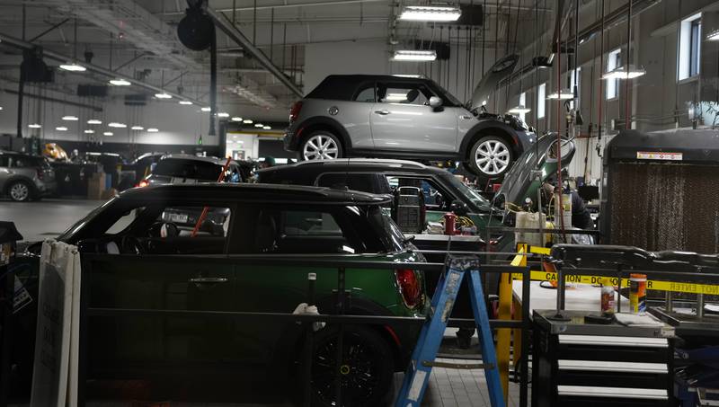 FILE - Cooper models are tended to in the service bay of a Mini dealership Nov. 3, 2022, in Highlands Ranch, Colo. On Friday, June 27, 2024, the government reports on the inflation gauge that the Federal Reserve follows most closely, a data set that will influence the Fed's decision on when to begin cutting interest rates in the coming months. (AP Photo/David Zalubowski, File)