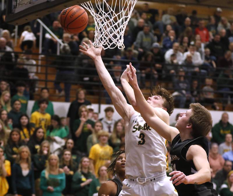 Crystal Lake South's Colton Hess drives to the basket against Kaneland's Troyer Carlson during the IHSA Class 3A Kaneland Boys Basketball Sectional championship game on Friday, March 1, 2024, at Kaneland High School in Maple Park.