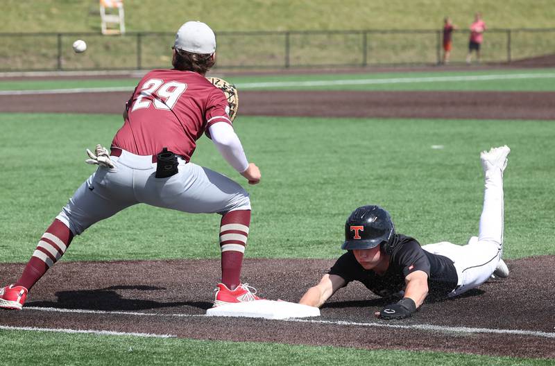 Crystal Lake Central's Carter Kelley gets back to first safely as Morris' Merek Klicker takes the throw on a pickoff attempt during their Class 3A state semifinal game Friday, June 7, 2024, at Duly Health and Care Field in Joliet.