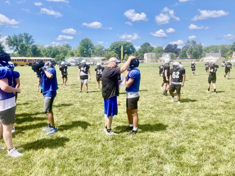 Princeton coach Ryan Pearson talks to a Tiger during Thursday's controlled scrimmage with Class 6A semifinalist Washington at Little Siberia.