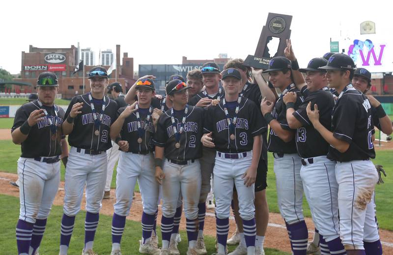 Members of the Wilmington baseball team hoist the Class 2A third place trophy on Saturday, June 1, 2024 at Dozer Park in Peoria.