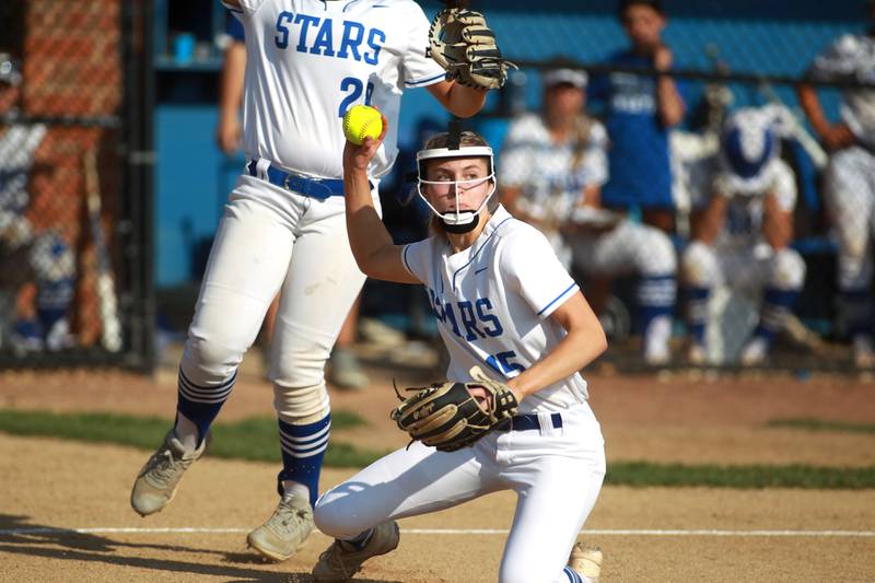 St. Charles North pitcher Paige Murray throws to first for an out during a home game against Wheaton Warrenville South on Monday, May 6, 2024.