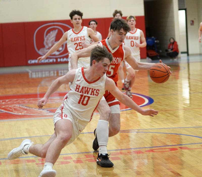 Morrison's Asher Ernst (15) portects the ball against Oregon's Keaton Salsbury (10) during 2A regional action on Monday, Feb. 19, 2024 at the Blackhawk Center in Oregon. The Mustangs downed the Hawks 59-52 to advance to the Prophetstown Regional on Wednesday, Feb. 21.