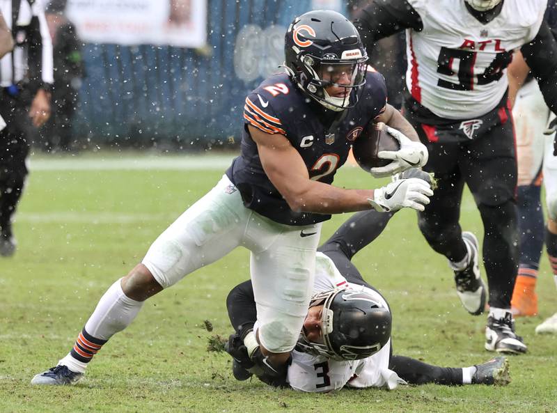 Chicago Bears wide receiver DJ Moore tries to break away from Atlanta Falcons safety Jessie Bates III during their game Sunday, Dec. 31, 2023, at Soldier Field in Chicago.