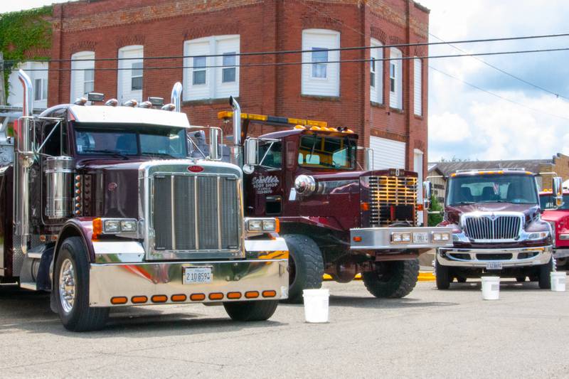 Tow Trucks from Scholle's Towing & Body Shop in Peru park on Main Avenue on Saturday, July 20, 2024 at the Convoy Against Cancer Big Truck Show in Ladd.