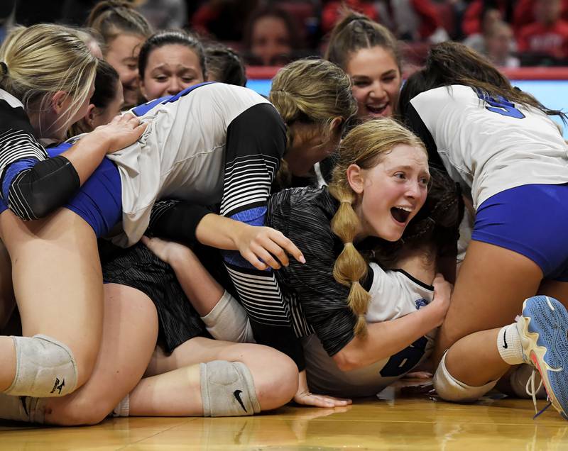 St. Francis’ Catherine D'Orazio looks ouot from a pile of teammates as they celebrate a championship after defeating Lincoln in the Class 3A girls volleyball state championship match at Illinois State University in Normal on Saturday, October 11, 2023.