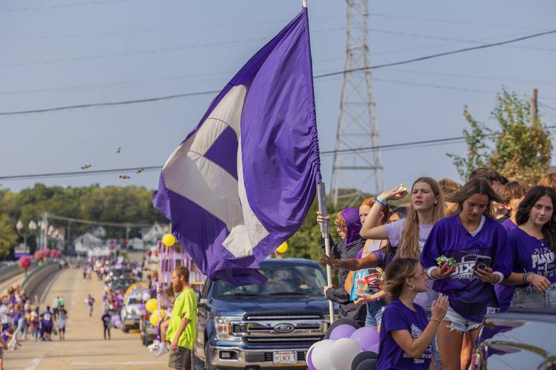 The Dixon High School cross country team throws candy from their float Friday, Sept. 29, 2023 during homecoming parade.