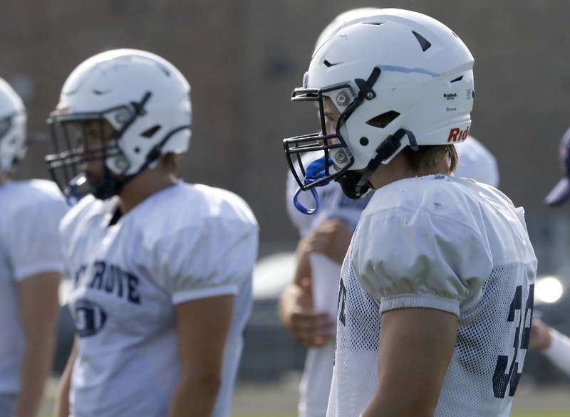 Holden Boone listens to head coach Brad Seaburg talk during football practice Tuesday, Aug. 20, 2024, at Cary-Grove High School, as the 2023 IHSA Class 6A champions look to defend their title.