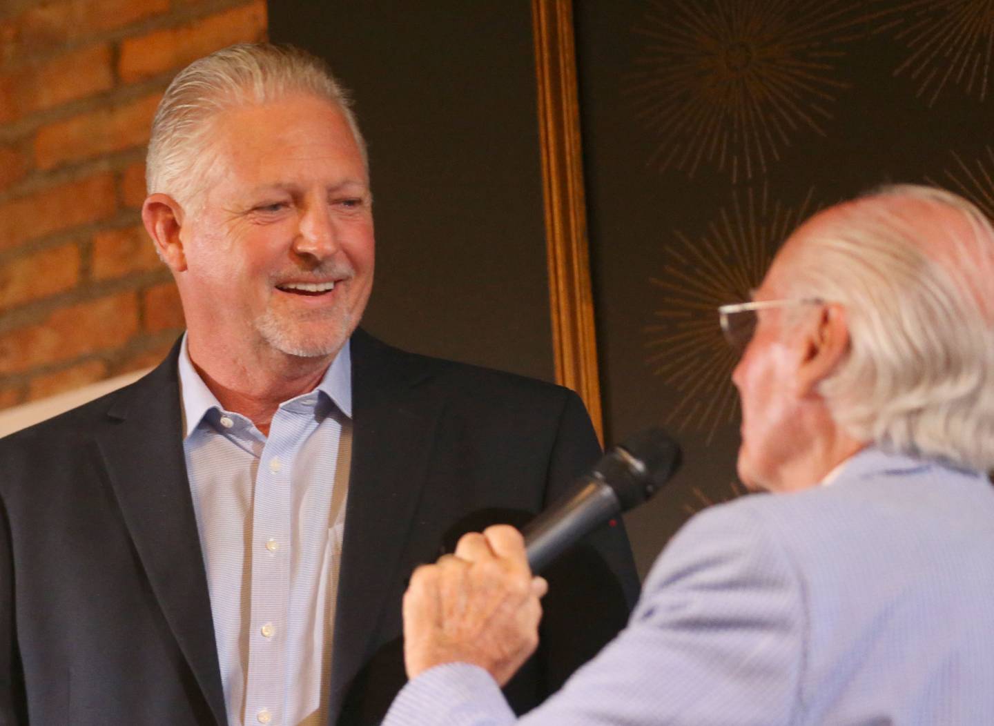 Craig McCormick speaks with emcee Lanny Slevin during the Illinois Valley Sports Hall of Fame awards banquet on Thursday, June 6, 2024 at the Auditorium Ballroom in La Salle.