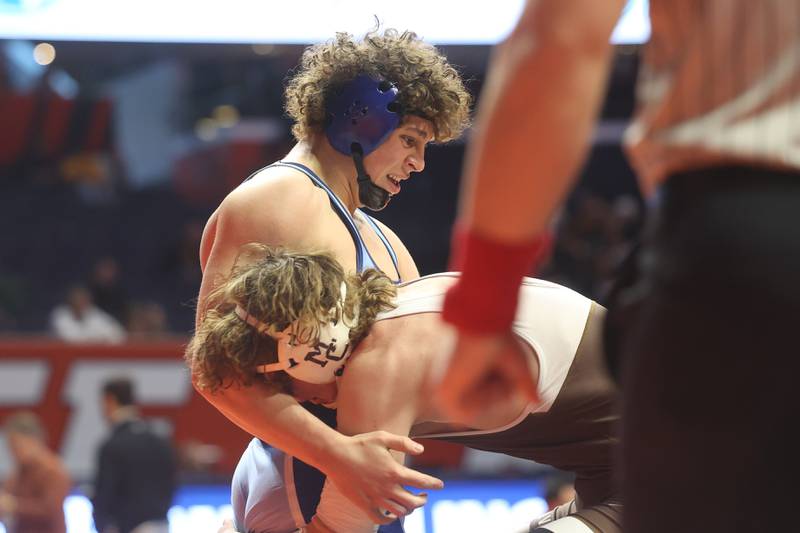 Downers Grove South’s Matt Lapaceik grabs Mount Carmel’s Ryian Breen in the 190-pound Class 3A state 3rd place match on Saturday, Feb. 17th, 2024 in Champaign.