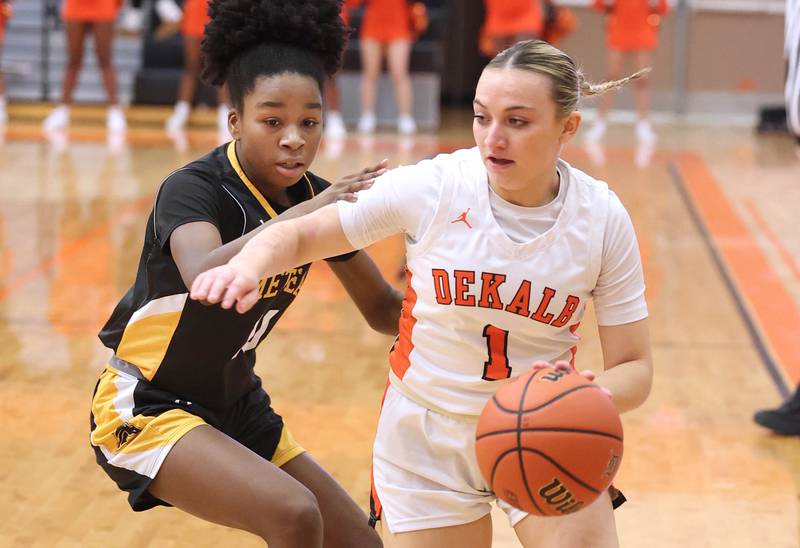 DeKalb’s Ella Russell goes around Metea Valley's Arainna Hammons during their game Friday, Jan. 19, 2024, at DeKalb High School.