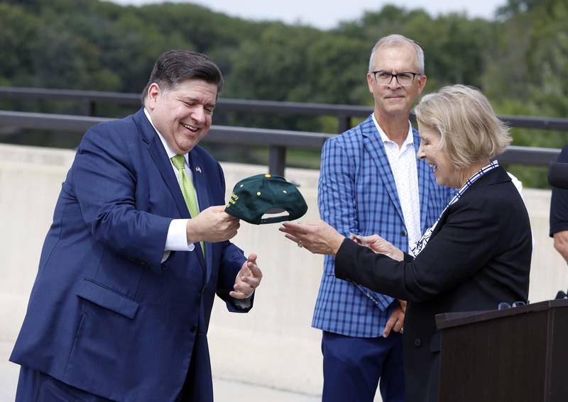 Illinois Gov. JB Pritzker accepts a commemorative hat from Kane County Board Chairman Corinne Pierog during the ceremony for the long-awaited opening of Longmeadow Parkway over the Fox River Thursday, Aug. 29, 2024 in Algonquin.