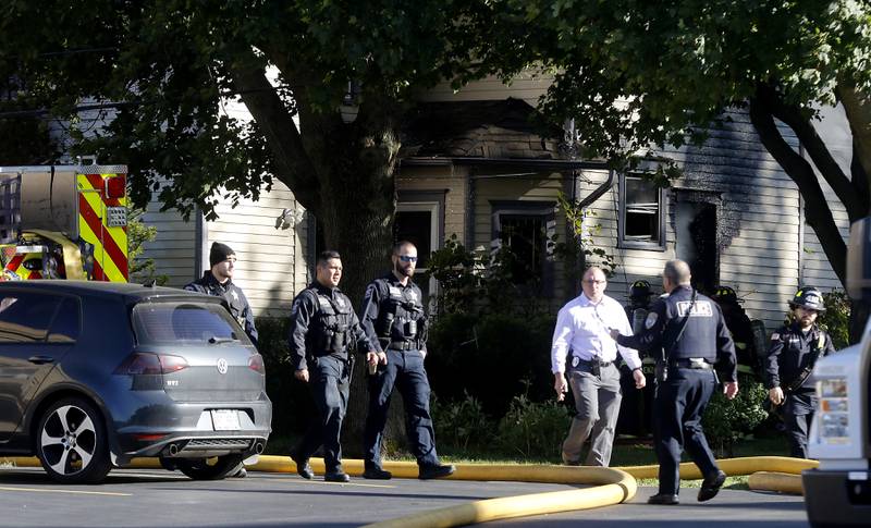 Police and firefighters at the scene of a house fire in the 300 block of Lincoln Avenue in Woodstock Monday, Oct. 9, 2023, after an explosion following suspected gas leak in the area.