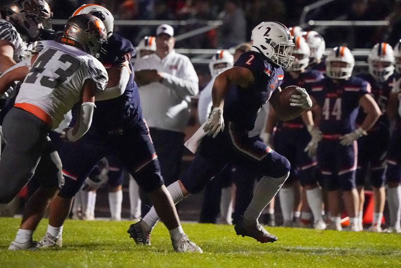 Oswego’s Lucas Andersen (2) carries the ball against Minooka during a football game at Oswego High School on Friday, October 18, 2024.