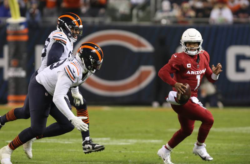 Chicago Bears defensive tackle Gervon Dexter Sr. and defensive end Montez Sweat chase Arizona Cardinals quarterback Kyler Murray out of the pocket in the fourth quarter of their game Sunday, Dec. 24, 2023, at Soldier Field in Chicago.