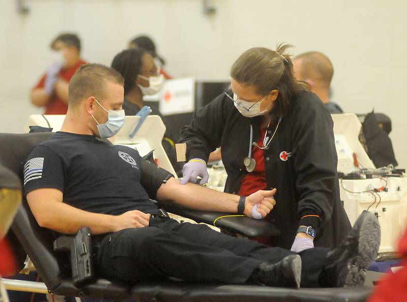 Mike Kuvales, an area law enforcement  officer who worked with Jake Keltner, donates blood during the third annual Jake Keltner Memorial Blue Blood Drive on law enforcement appreciation day Sunday, Jan. 9, 2022, at the Sage YMCA.McHenry County Sheriffs Deputy Jake Keltner was killed in the line of duty serving an arrest warrant in Rockford in March, 2019.  All 230 appointments to donate blood were filled this year.