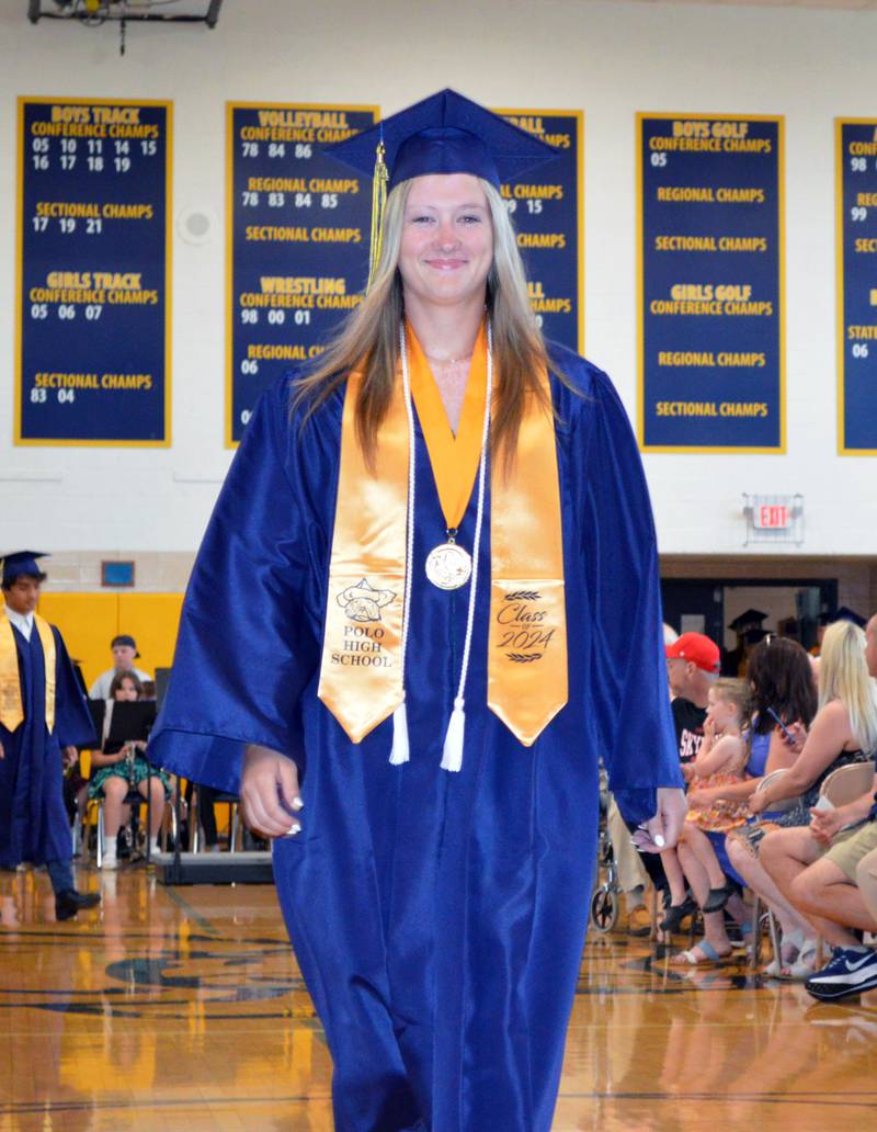 Polo Community High School Class of 2024 salutatorian Karlea Frey walks toward the stage at the start of the commencement ceremony on Sunday, May 19, 2024.
