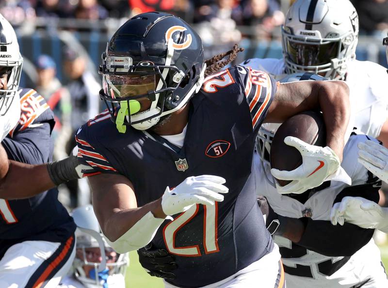 Chicago Bears running back D'Onta Foreman (21) gets outside of the Las Vegas Raiders defense during their game Sunday, Oct. 22, 2023, at Soldier Field in Chicago.