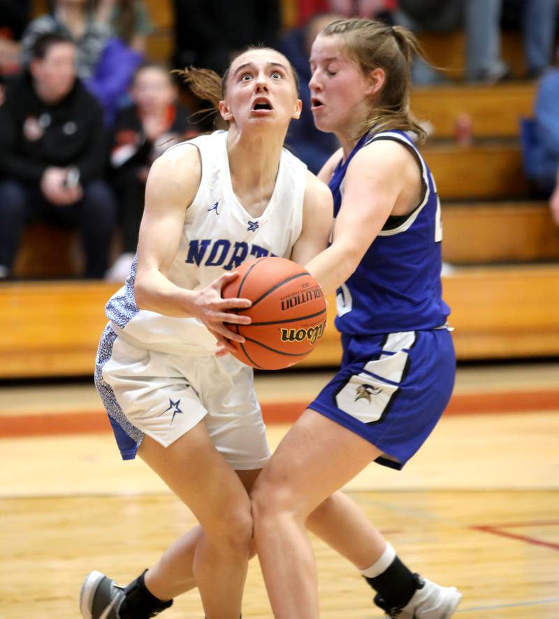 St. Charles North’s Laney Stark gets past Geneva’s Caroline Madden for an open shot during a Class 4A Batavia Sectional semifinal game on Tuesday, Feb. 20, 2024.
