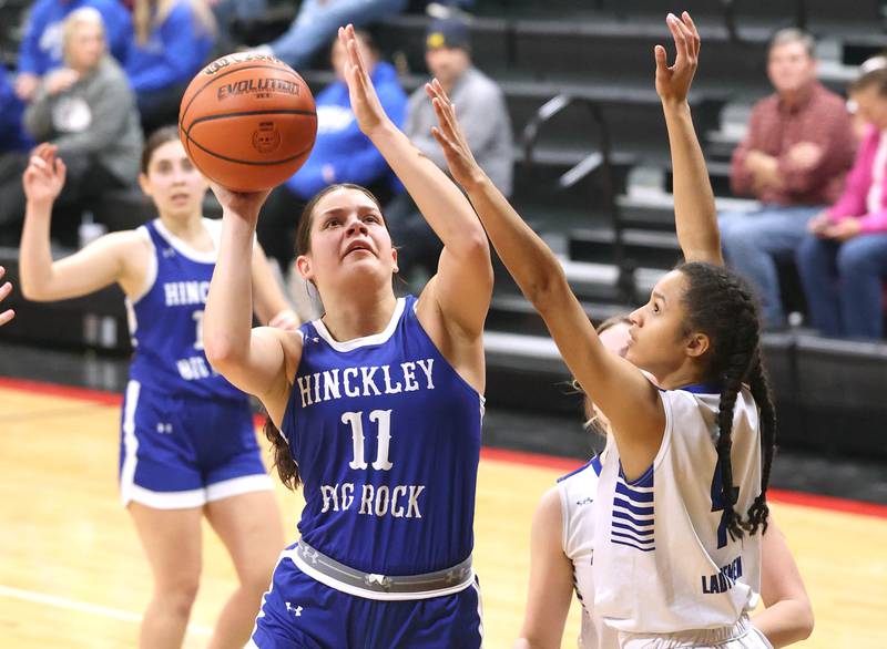 Hinckley-Big Rock's Raven Wagner shoots over Newark’s Kiara Wesseh Thursday, Jan. 18, 2024, during the Little 10 girls basketball tournament at Indian Creek High School in Shabbona.