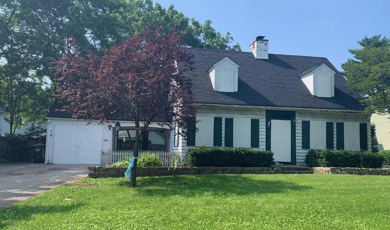 The boards covering the windows and doors of the Dole Avenue home in which AJ Freund lived recently were painted white.