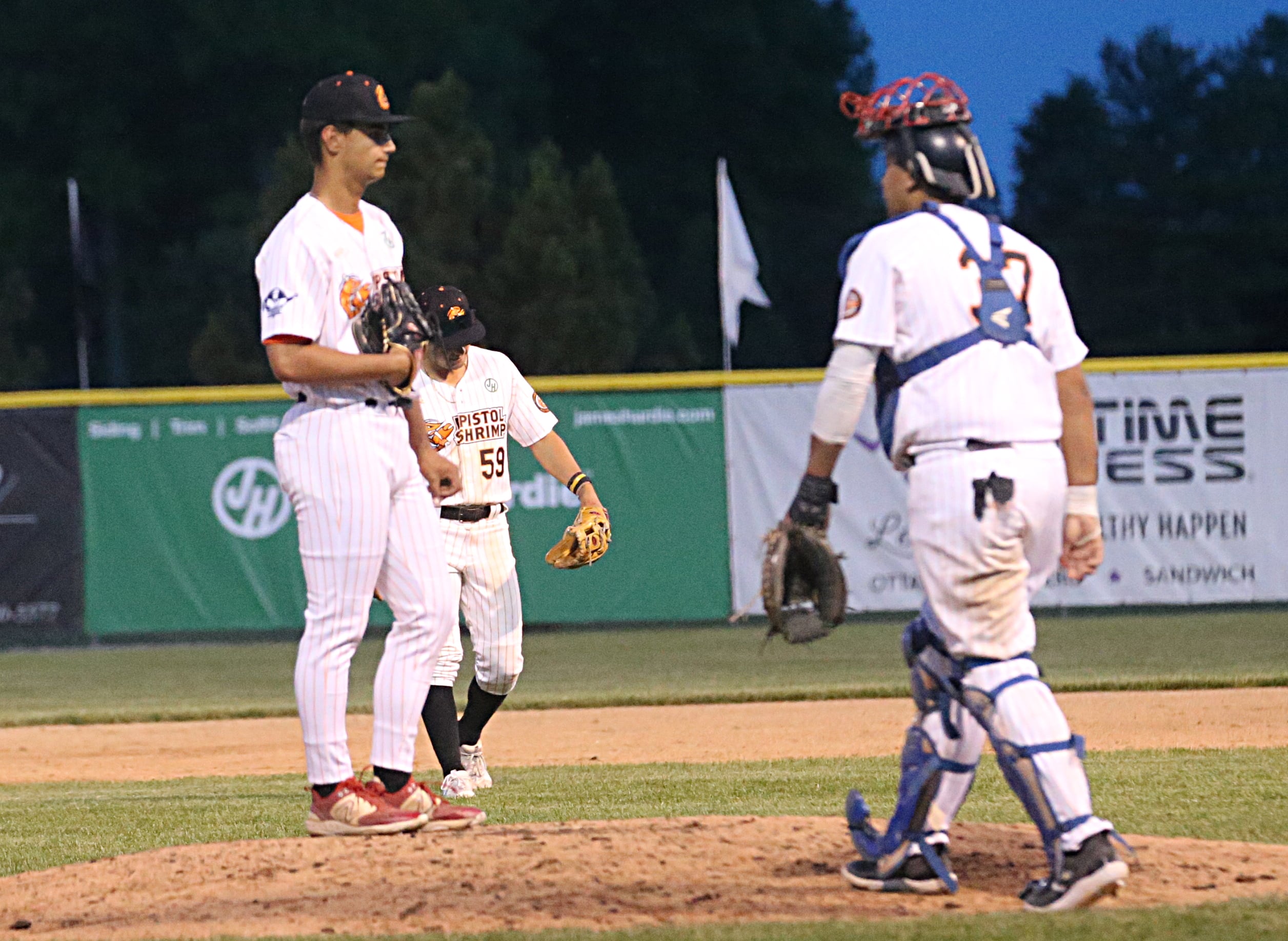 Former Ottawa High School baseball standout Payton Knoll stands on the mound as his Illinois Valley Pistol Shrimp teammates talk to him in Schweickert Stadium earlier this season at Veterans Park in Peru.