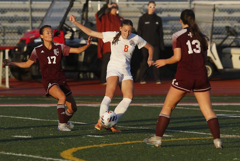 Crystal Lake Central's Peyton McMahon control the ball between St. Ignatius College Prep's Lauren Reed and Lili Garcia during the Class 2A Deerfield Supersectional girls soccer match on Tuesday, May 28, 2024, at Deerfield High School.