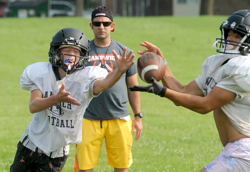 Sandwich's Gage Judd (left) and Axavier Hernandez learn new pass routes and how to defend them during early summer football practice at Sandwich High School on Monday, July 17, 2023.