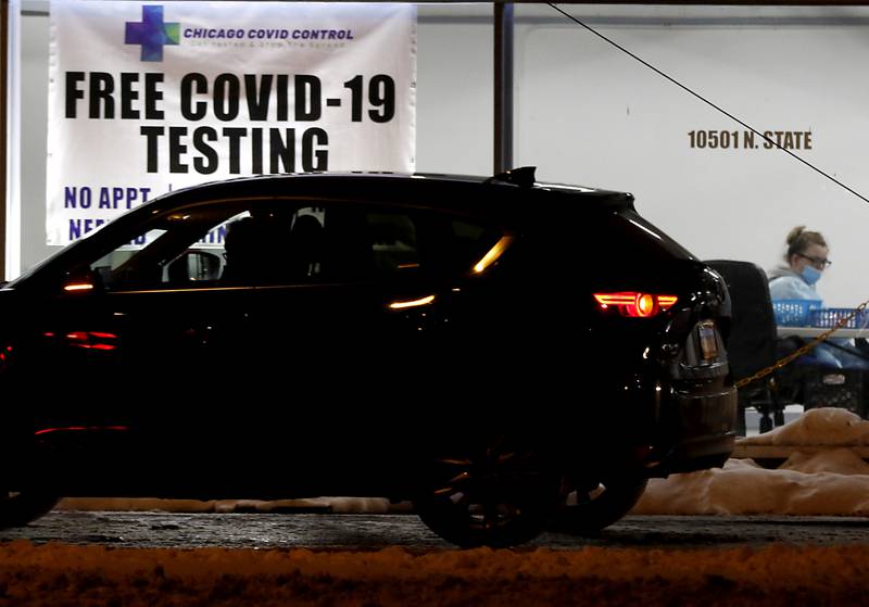 A person waits in their car for the results of a COVID-19 test Monday, Jan. 24, 2022, at Chicago Covid Control testing site in Huntley.